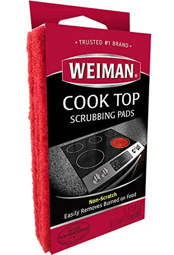 Weiman cook top scrubbing pads cleaning a glass stove top