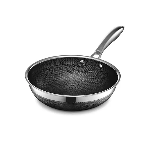 HexClad hybrid nonstick wok with hexagonal pattern on electric stove
