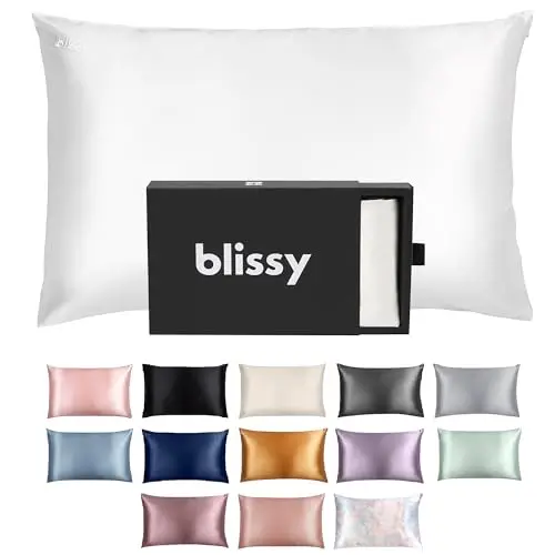 BLISSY white silk pillowcase laid flat on a bed