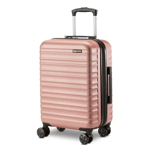 Amazon Basics hardside carry-on luggage in rose gold with spinner wheels