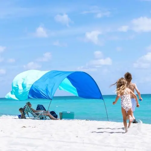 Shibumi Shade Classic wind-powered beach canopy floating above sand